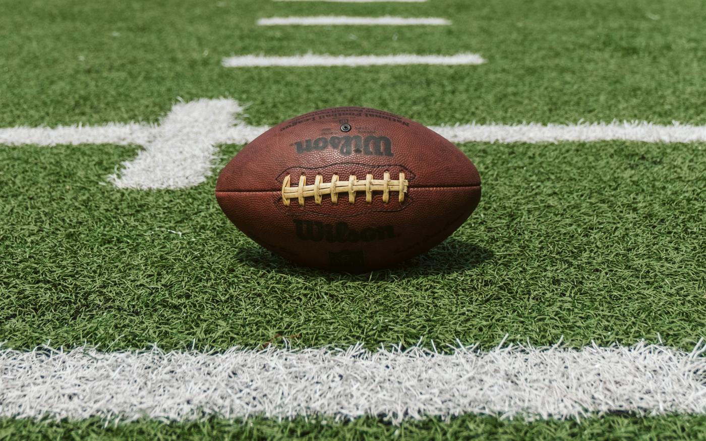 brown and black Wilson football by Dave Adamson courtesy of Unsplash.