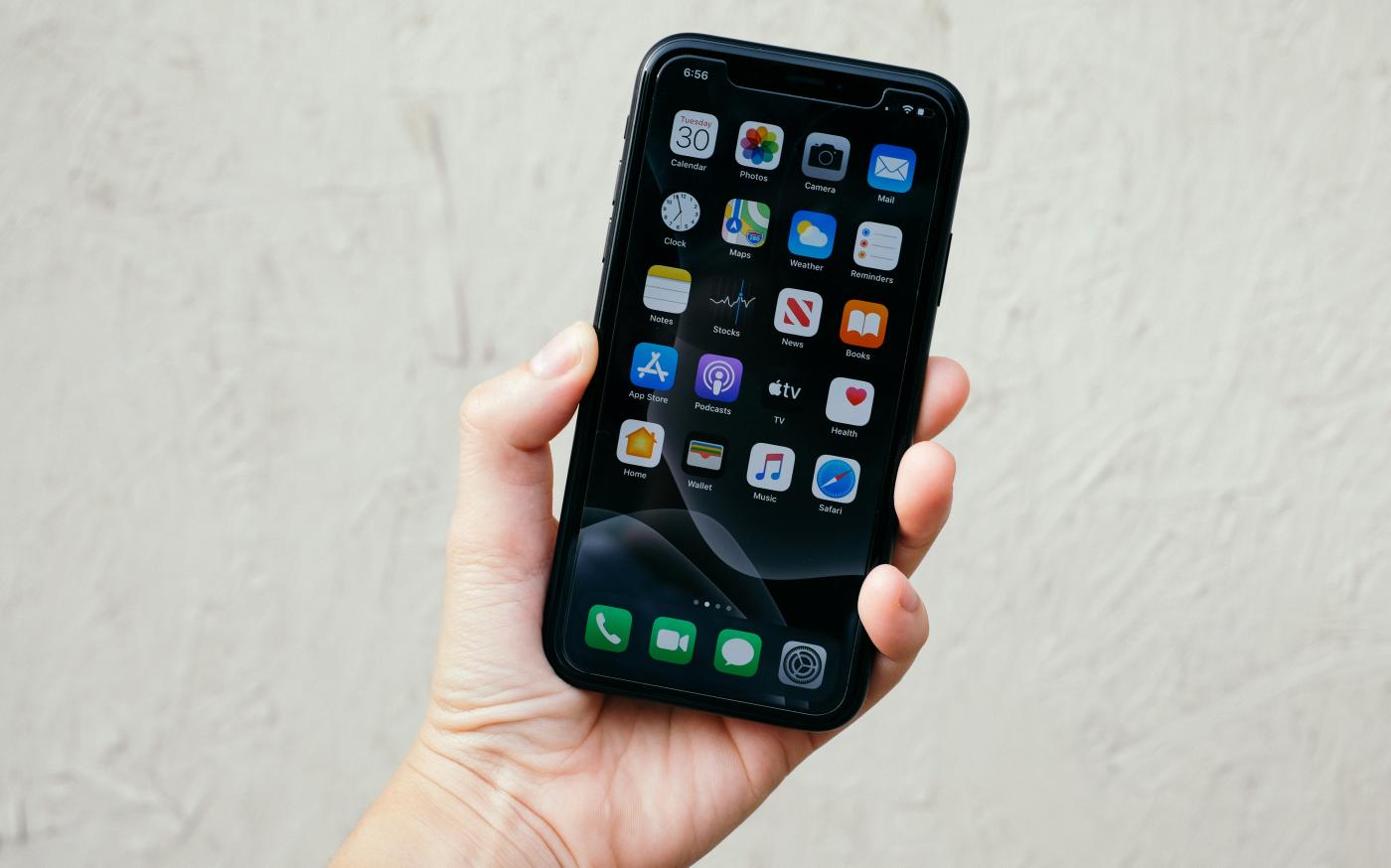 person holding black iphone 5 by Fujiphilm courtesy of Unsplash.